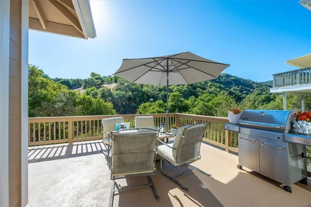 a living room with furniture large window and a fireplace