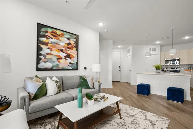 a kitchen with stainless steel appliances a refrigerator sink and wooden floor