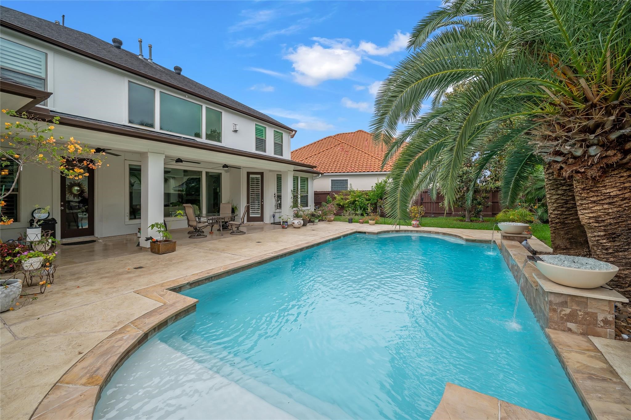 2127 Thicket Ridge Lane Houston, TX 77077 - Photo 43 of 50 Take note of the large covered patio which features four ceiling fans, a travertine patio and direct access to the full pool bath.