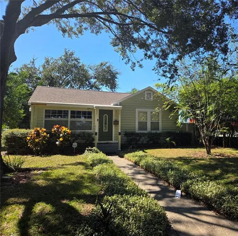 a front view of a house with yard and green space
