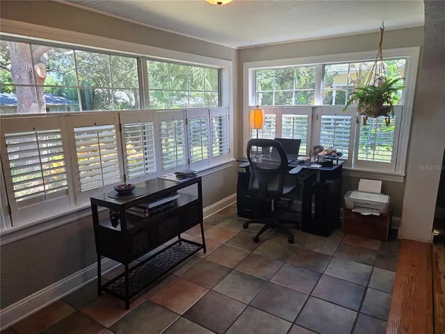 a living room with furniture and large windows