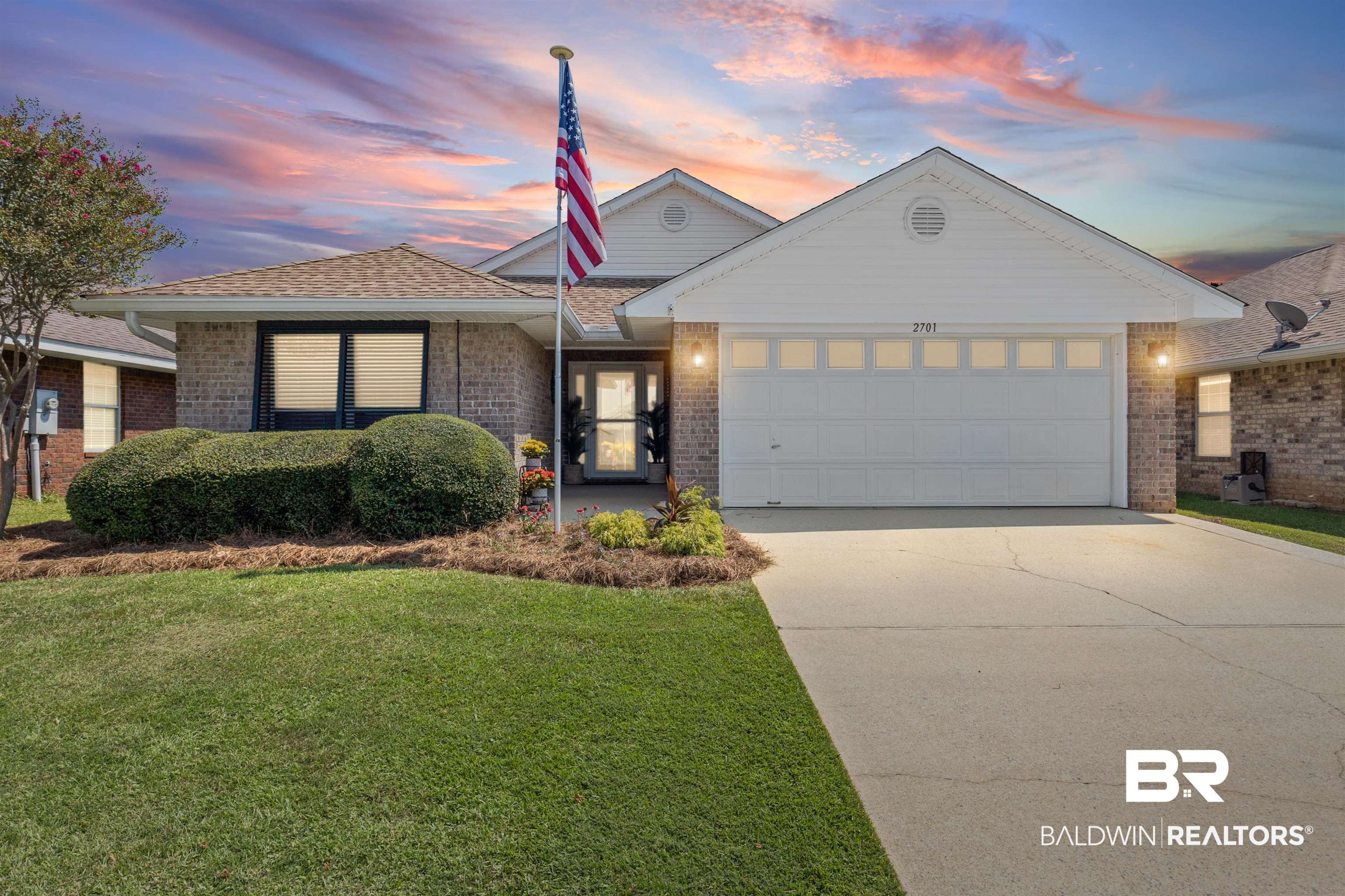2701 Hampton Park Circle Foley, AL 36535 - Photo 43 of 44 Ranch-style house featuring a garage, driveway, brick siding, and a front lawn
