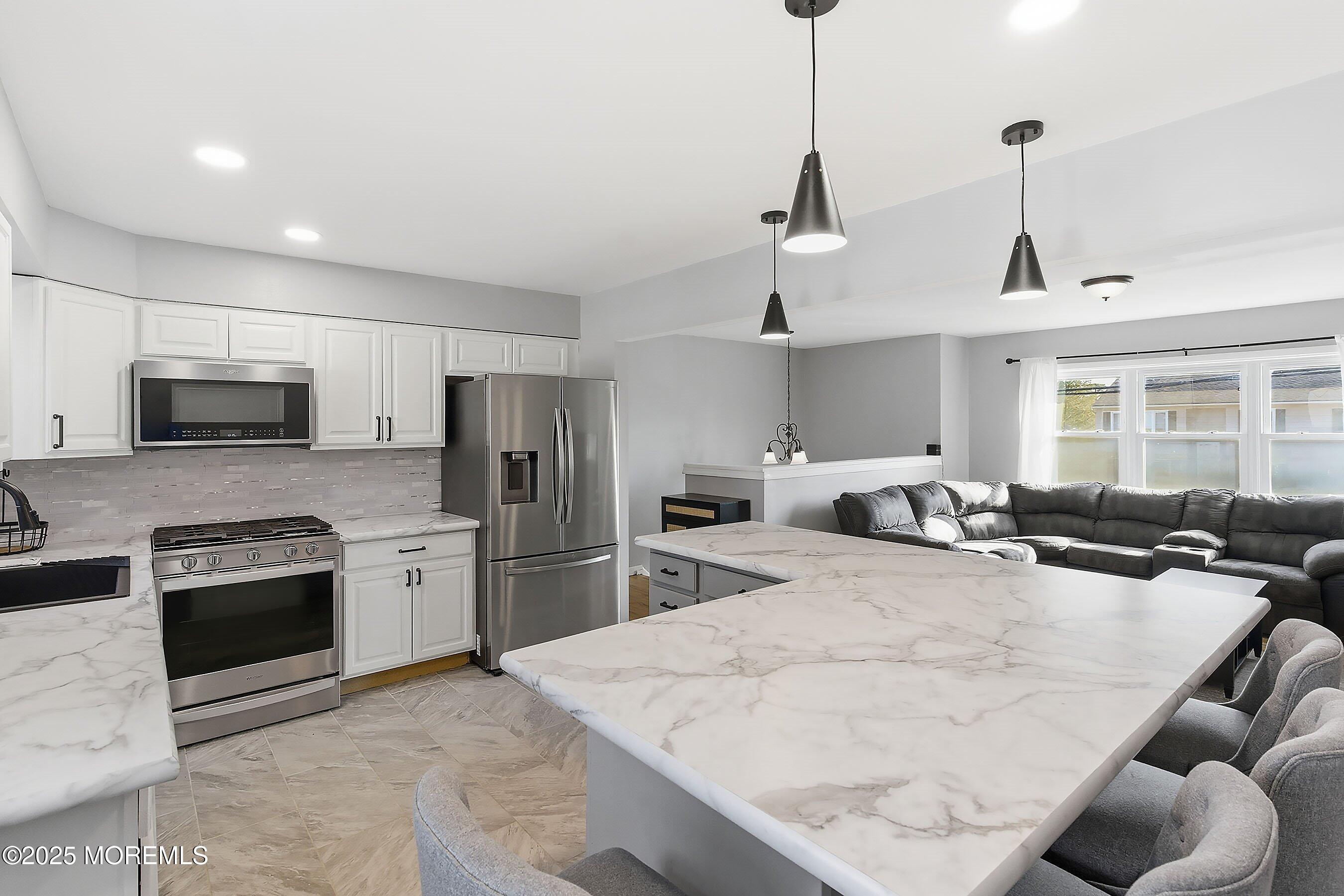 2178 Lanes Mill Road Brick, NJ 08724 - Photo 11 of 34 a kitchen with stainless steel appliances granite countertop a sink dishwasher stove top oven and refrigerator