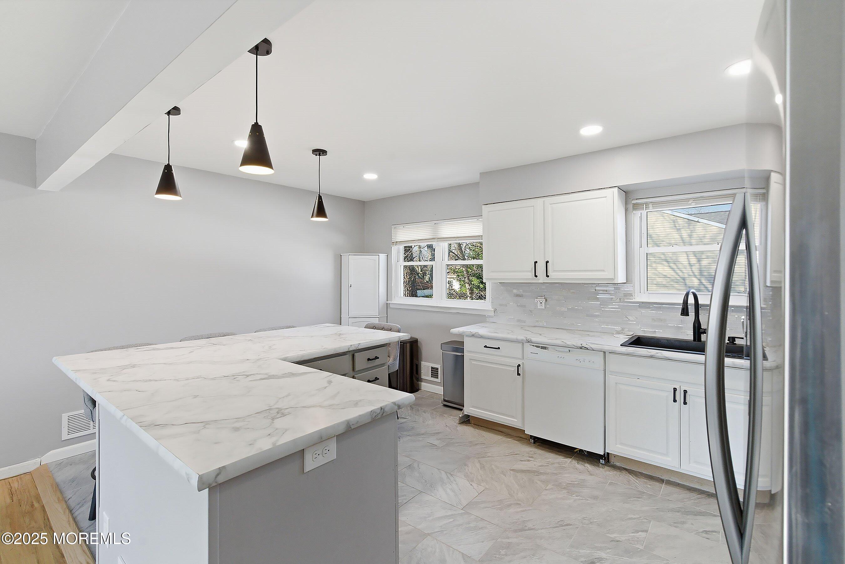 2178 Lanes Mill Road Brick, NJ 08724 - Photo 12 of 34 a kitchen with a sink a stove and cabinets