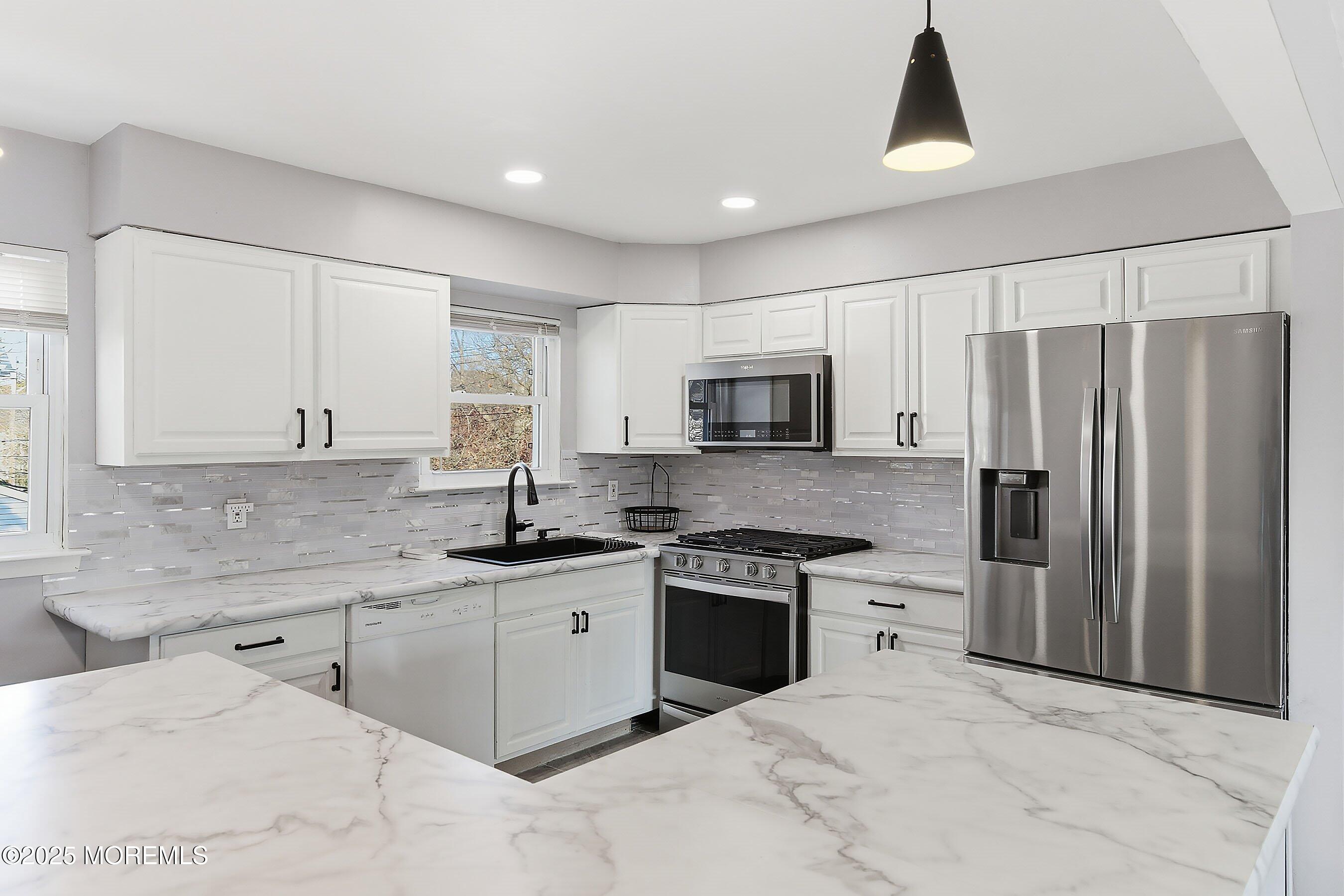 2178 Lanes Mill Road Brick, NJ 08724 - Photo 13 of 34 a kitchen with stainless steel appliances granite countertop a sink stove and refrigerator