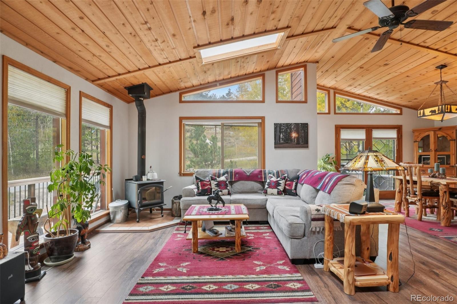 42 Catamount Ridge Road Bailey, CO 80421 - Photo 2 of 36 a living room with furniture a rug and a chandelier