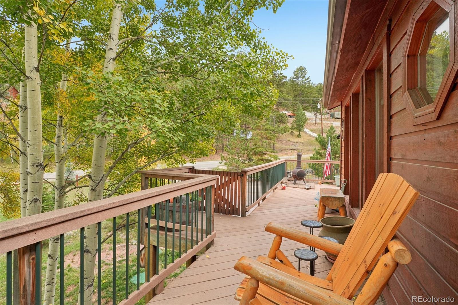 42 Catamount Ridge Road Bailey, CO 80421 - Photo 23 of 36 a balcony with wooden floor and outdoor seating