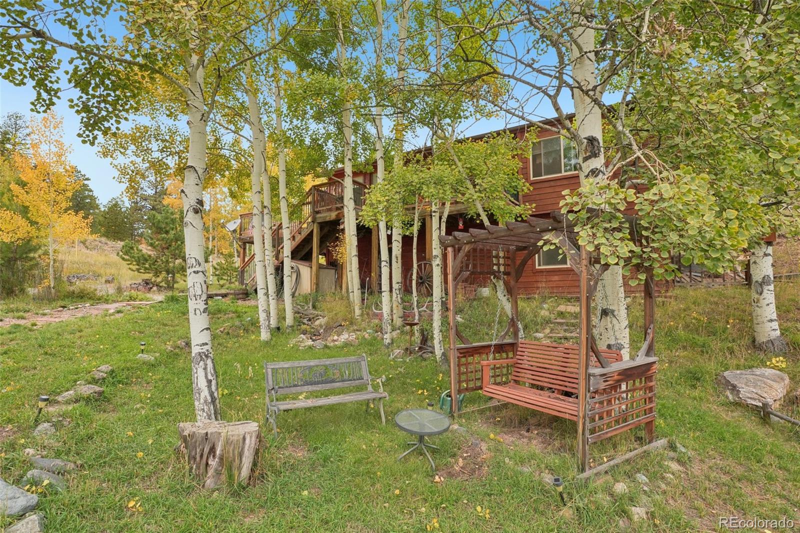 42 Catamount Ridge Road Bailey, CO 80421 - Photo 26 of 36 a backyard of a house with table and chairs