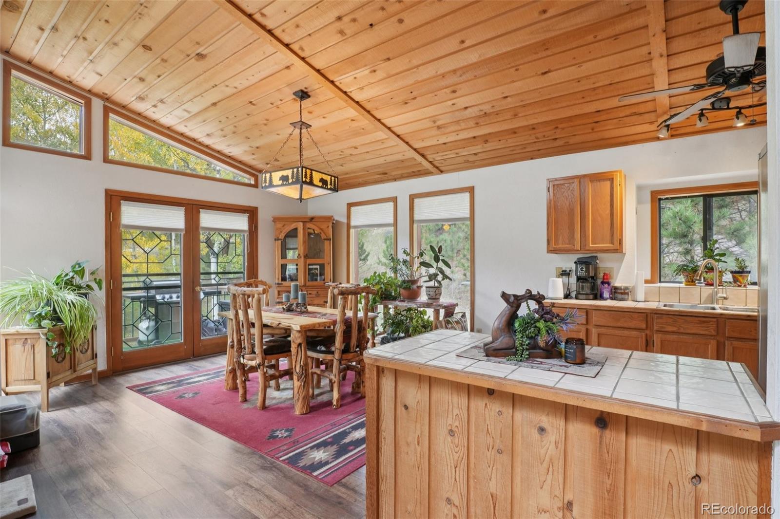 42 Catamount Ridge Road Bailey, CO 80421 - Photo 6 of 36 a view of a dining room with furniture wooden floor and chandelier