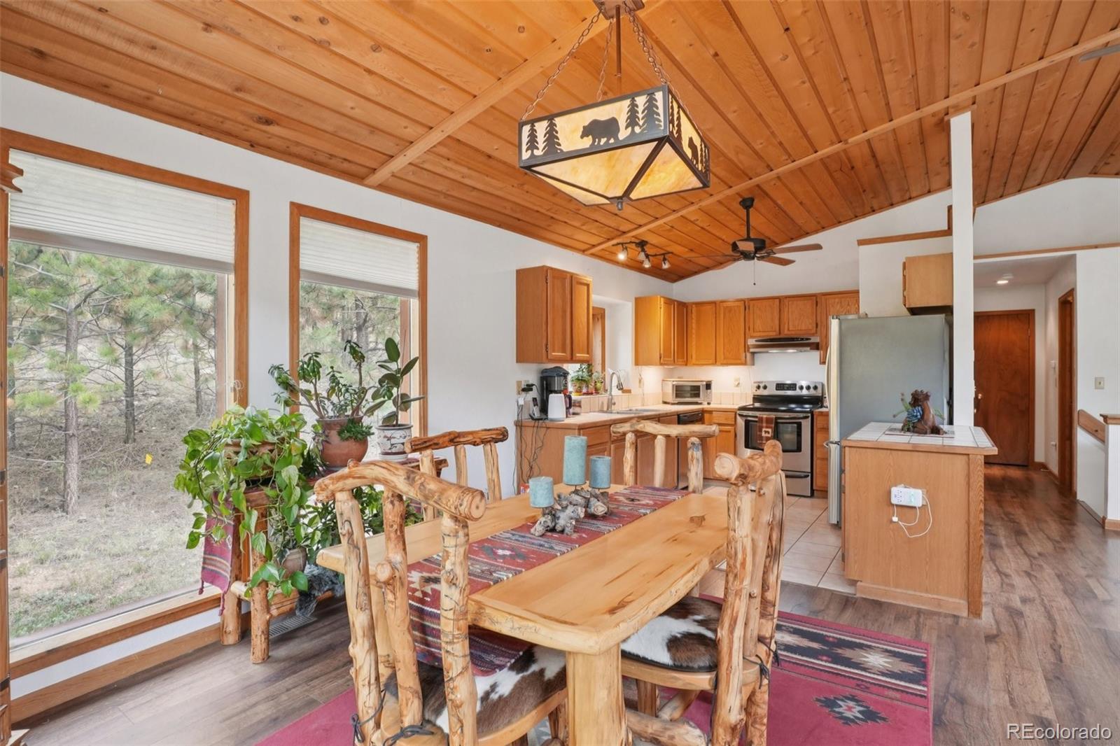 42 Catamount Ridge Road Bailey, CO 80421 - Photo 8 of 36 a view of a dining room with furniture window and wooden floor