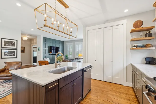 a kitchen with stainless steel appliances granite countertop a sink and cabinets