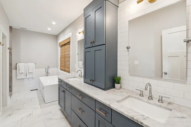 a spacious bathroom with a double vanity sink and a mirror