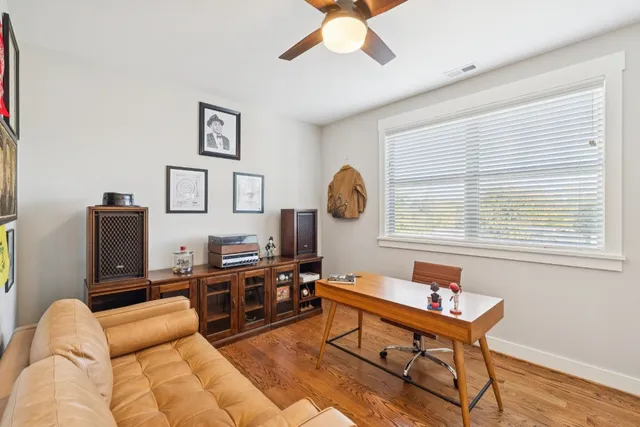 a living room with furniture a rug and a window