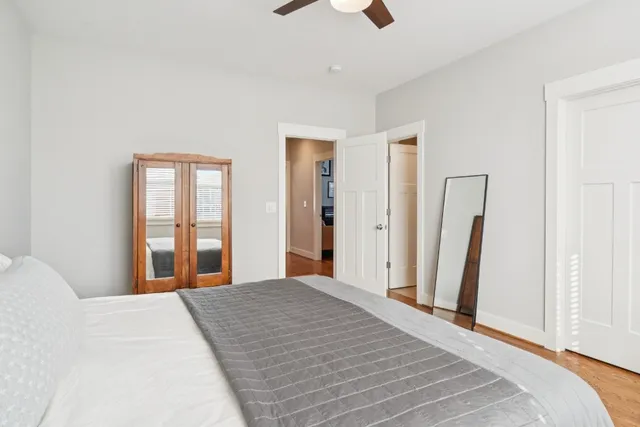 a bedroom with a bed and a large window