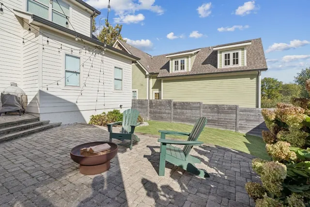 a view of a chairs and table in backyard
