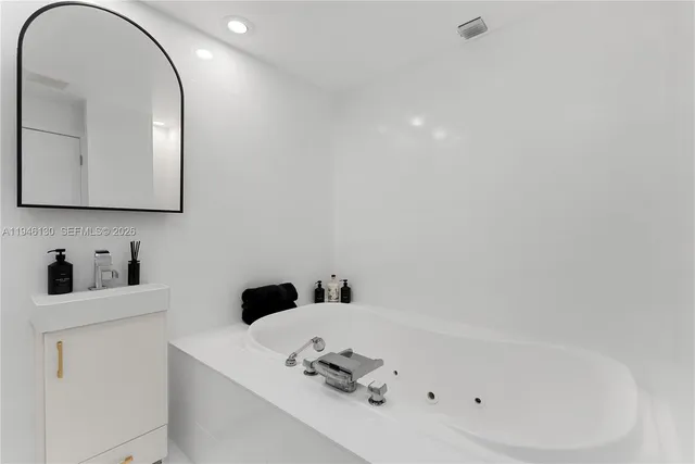 a bathroom with a sink vanity and a mirror