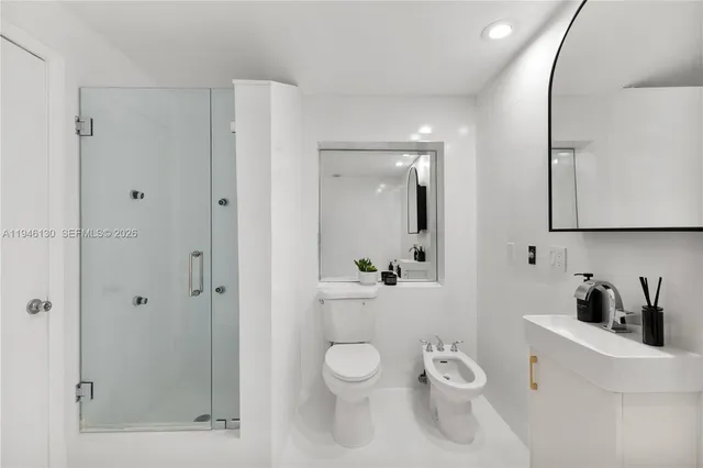 a bathroom with a toilet a sink and shower