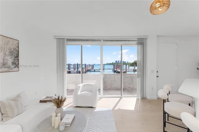 a living room with furniture and a floor to ceiling window