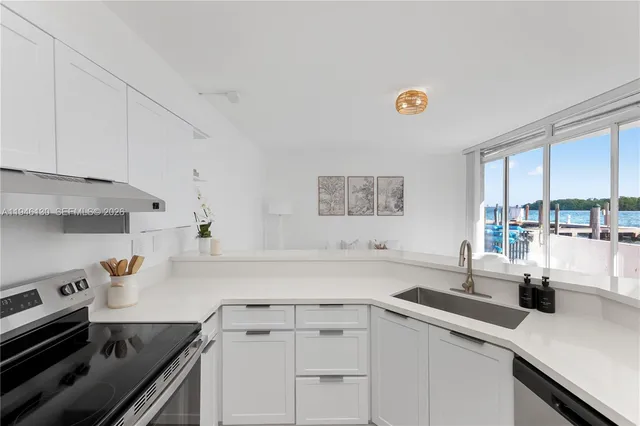 a kitchen with a sink cabinets and appliances