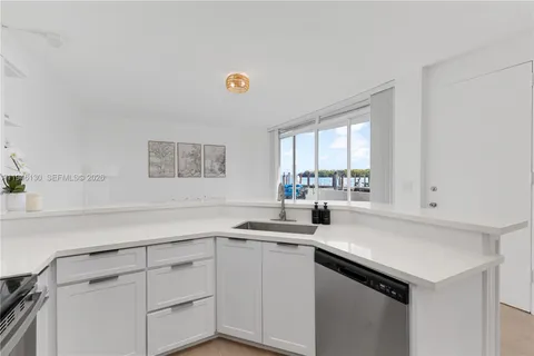 a kitchen with a sink cabinets and window