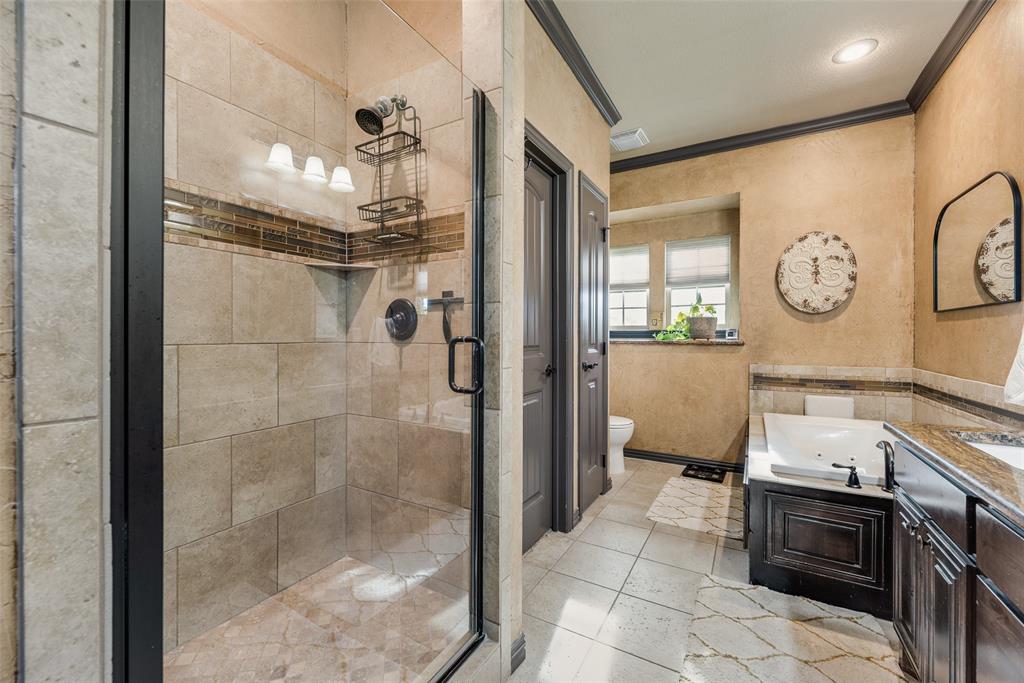 1132 Chartres Street Kaufman, TX 75142 - Photo 14 of 25 Glass-enclosed shower with tiled walls and a decorative accent band