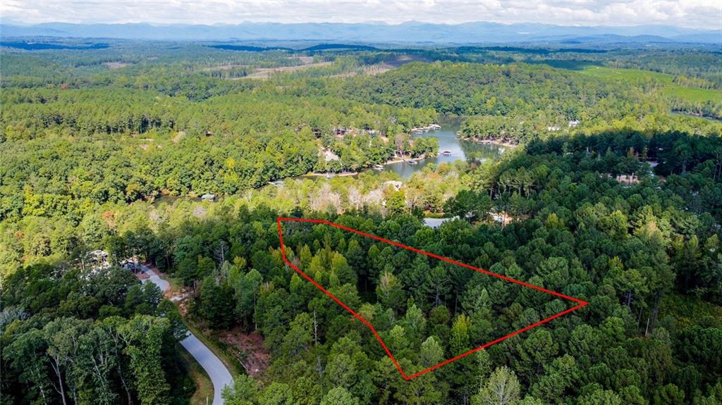 Lot 30 Harbor Point Seneca, SC 29672 - Photo 11 of 12 A tranquil wooded lot awaits, boasting access to a serene lake and picturesque mountain views.