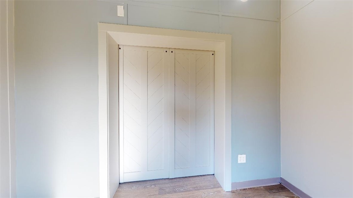 5585 Straub Road, Unit 110 College Station, TX 77845 - Photo 12 of 14 Unfurnished bedroom with wood finished floors
