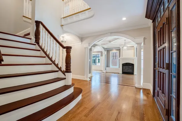 a view of entryway and hall with wooden floor