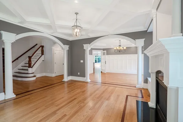 a view of a livingroom with wooden floor and stairs