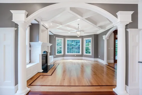 a view of an empty room with a fireplace and a window
