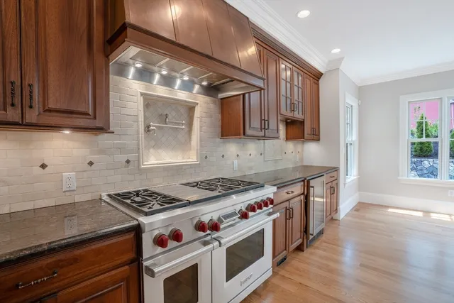 a kitchen with stainless steel appliances granite countertop a stove and a sink