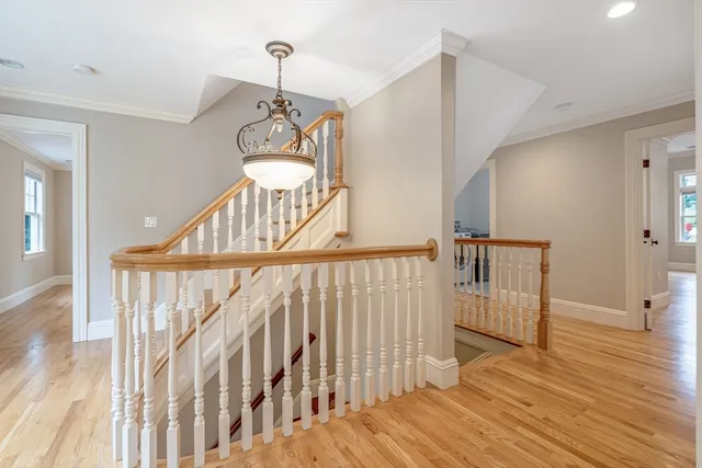 a view of staircase with railing and wooden floor