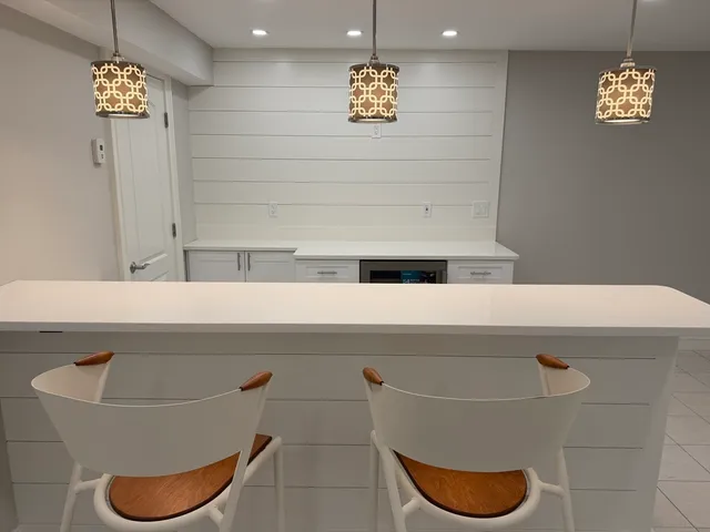 a kitchen with a sink a counter space and stainless steel appliances