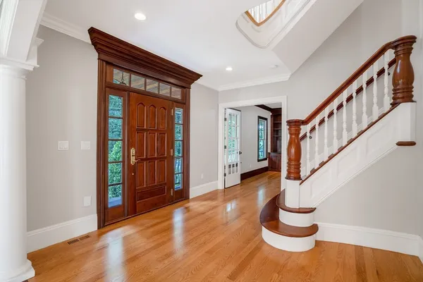 a view of entryway with wooden floor and stairs