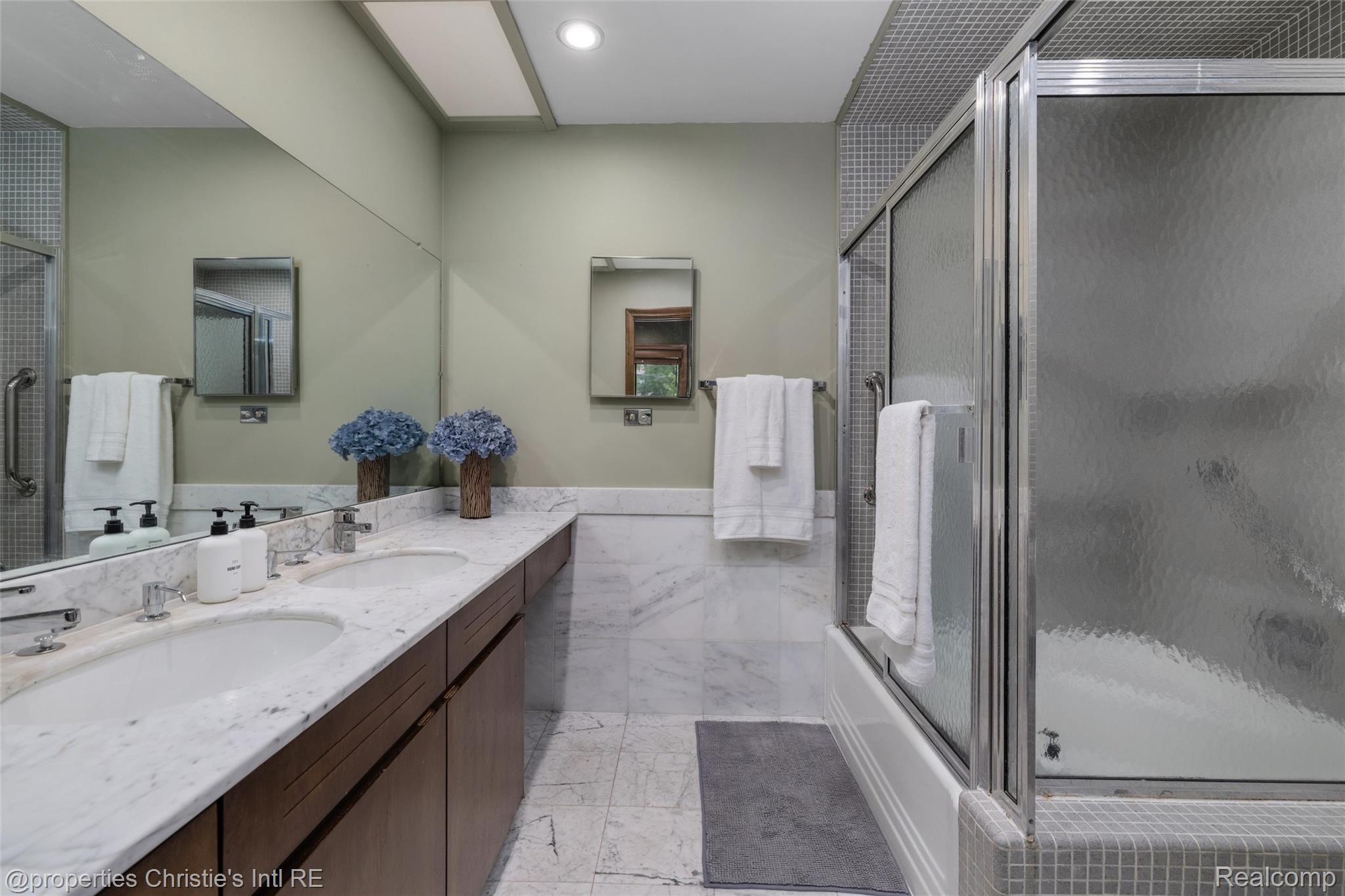 2771 West Seven Mile Road Detroit, MI 48221 - Photo 32 of 57 Bathroom featuring a dual-sink vanity with a white stone countertop, wood-finish cabinetry, and an integrated mirror