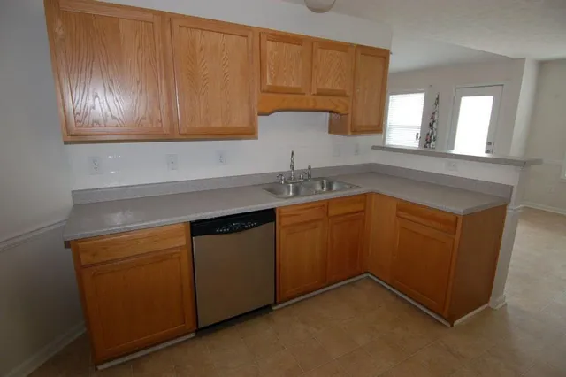 a kitchen with a sink cabinets and utility