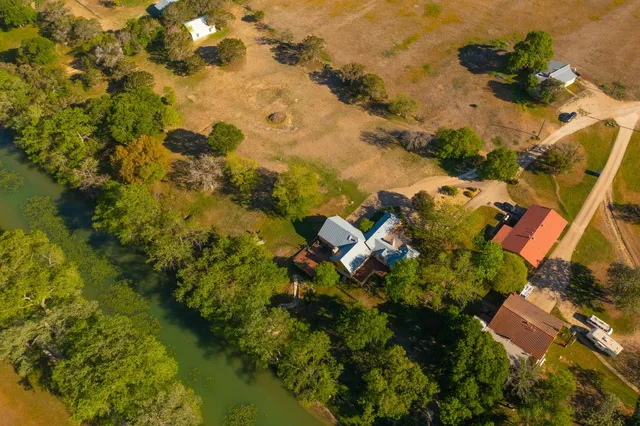 an aerial view of residential houses with outdoor space