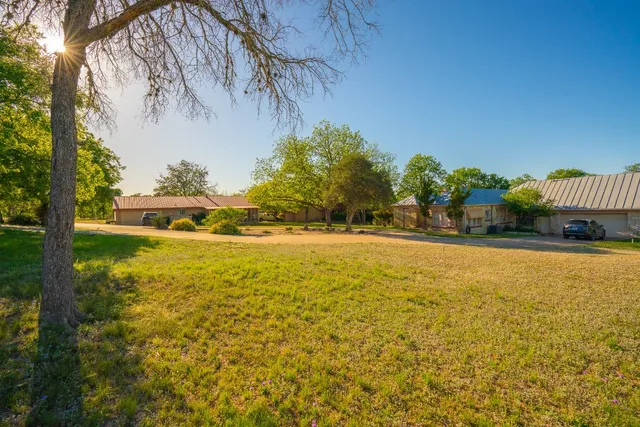 a view of yard with swimming pool and trees