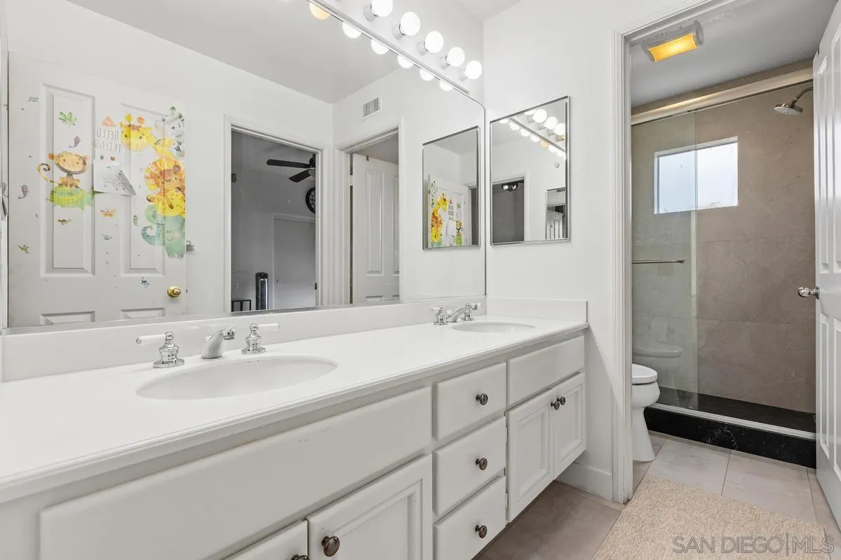 13847 Carmel Ridge Road San Diego, CA 92128 - Photo 22 of 40 a bathroom with a double vanity sink mirror and double
