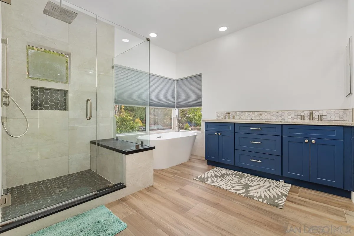 13847 Carmel Ridge Road San Diego, CA 92128 - Photo 28 of 40 a bathroom with a granite countertop sink and a mirror