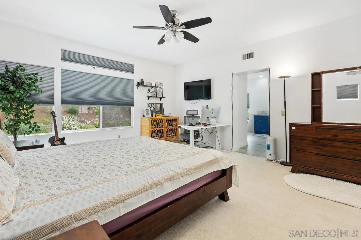 13847 Carmel Ridge Road San Diego, CA 92128 - Photo 31 of 40 a bedroom with a bed a window and dresser