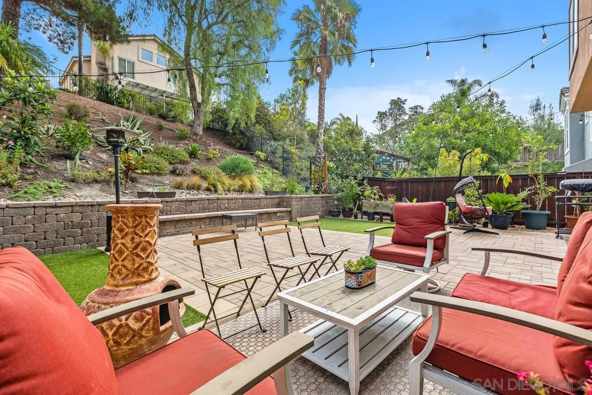 13847 Carmel Ridge Road San Diego, CA 92128 - Photo 33 of 40 a view of a patio with couches table and chairs and potted plants