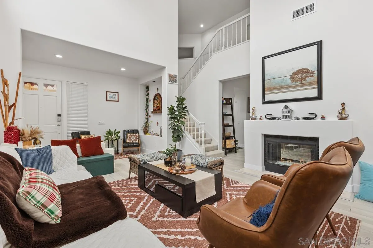 13847 Carmel Ridge Road San Diego, CA 92128 - Photo 6 of 40 a living room with furniture and a fireplace