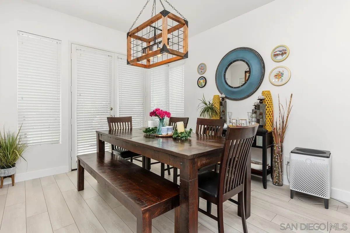 13847 Carmel Ridge Road San Diego, CA 92128 - Photo 7 of 40 a view of a dining room and kitchen with furniture and wooden floor