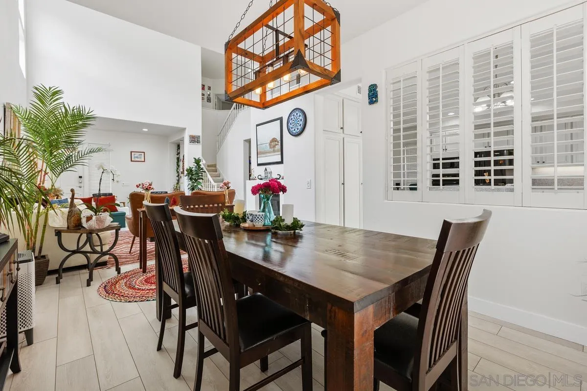 13847 Carmel Ridge Road San Diego, CA 92128 - Photo 8 of 40 a view of a dining room with furniture and chandelier