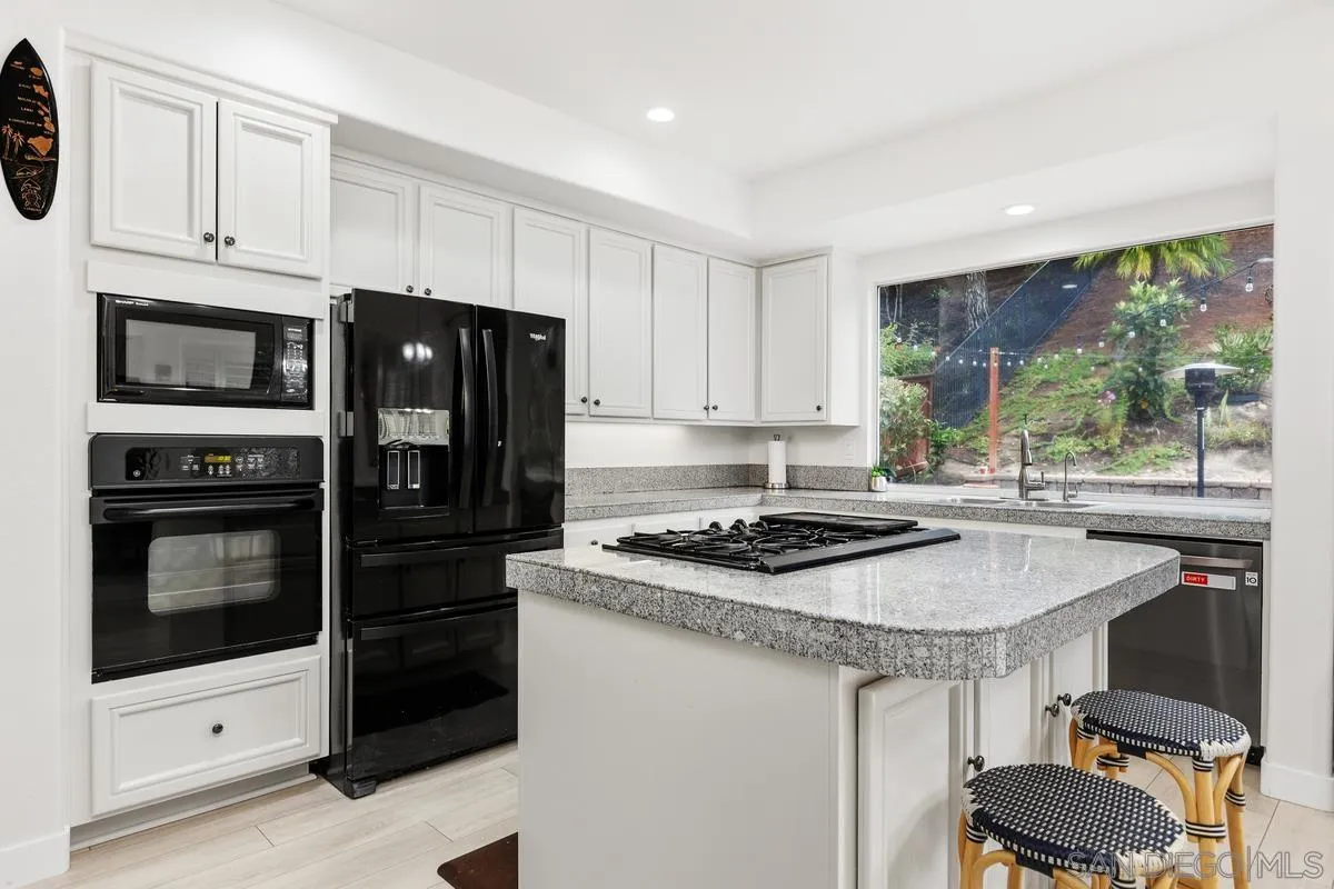 13847 Carmel Ridge Road San Diego, CA 92128 - Photo 10 of 40 a kitchen with a stove a sink and a refrigerator
