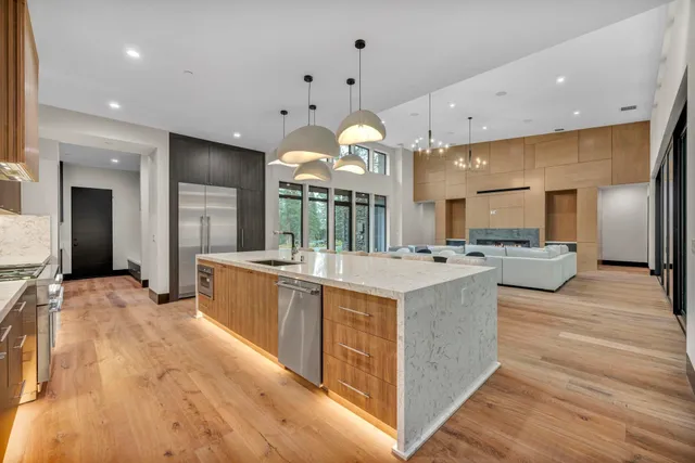 a large kitchen with a large counter top appliances and cabinets