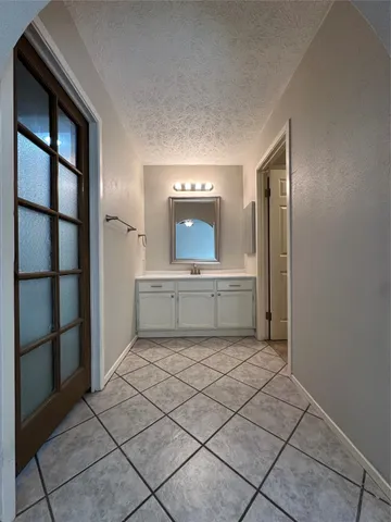 a view of an empty room with a ceiling fan