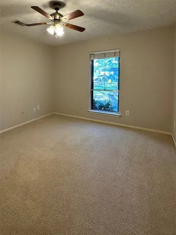 a view of a house with large trees