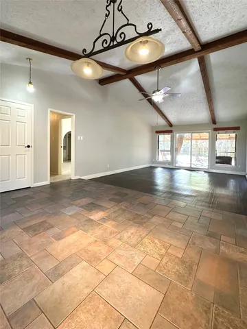 an aerial view of residential house with parking and yard